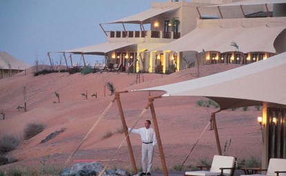Al Maha Desert Resort and Spa Dubai exterior view of white building with awnings in the desert
