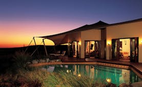 Al Maha Desert Resort and Spa Dubai Royal suite pool building with tented awning and private pool at night