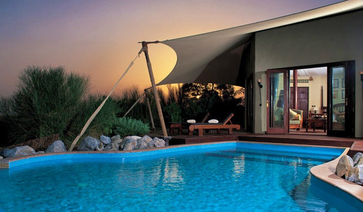 Al Maha Desert Resort and Spa Dubai suite pool with view to bedroom