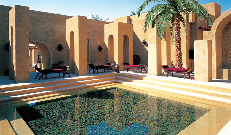 Bab Al Shams Desert Resort and Spa Dubai courtyard pool with red loungers