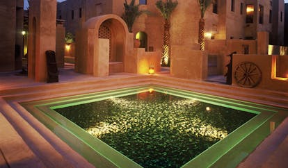 Bab Al Shams Desert Resort and Spa Dubai fountain night square pool in courtyard at night