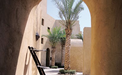 Bab Al Shams Desert Resort and Spa Dubai palms outdoor corridor and palm tree