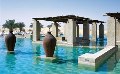 Bab Al Shams Desert Resort and Spa Dubai pool with covered area and urns