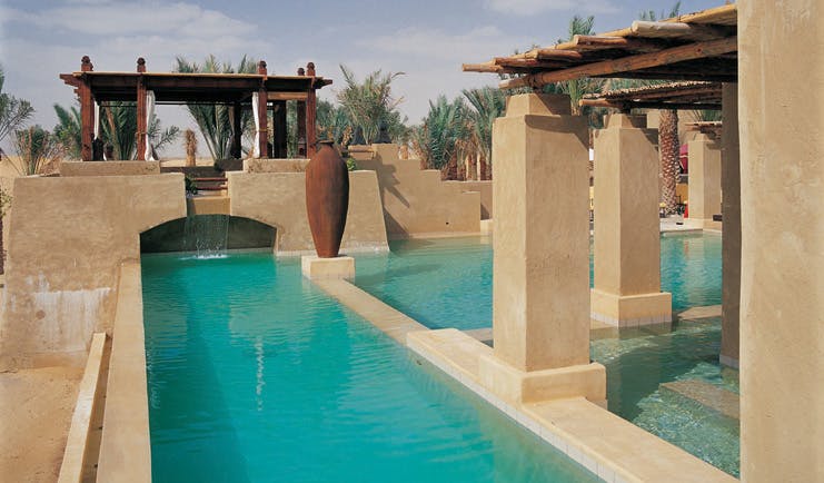 Bab Al Shams Desert Resort and Spa Dubai swimming pool with covered areas and cabana