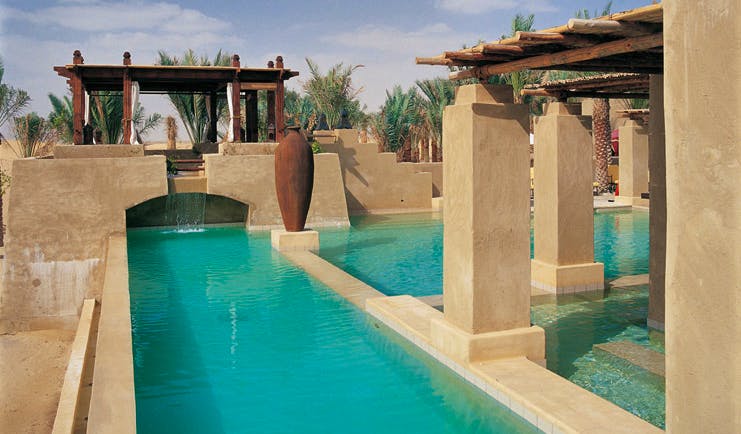 Bab Al Shams Desert Resort and Spa Dubai swimming pool with covered areas and cabana