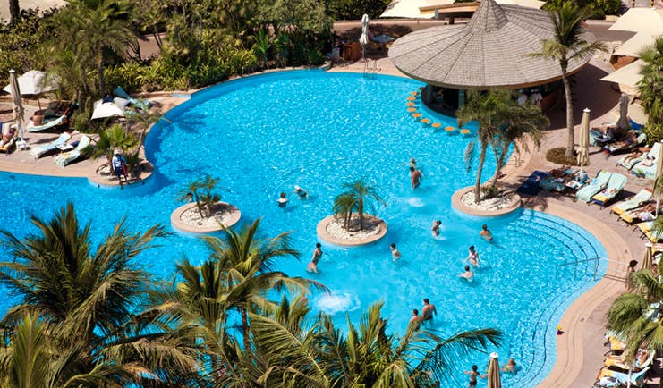 The Jumeirah Beach Hotel Dubai aerial outdoor pool with loungers and palm trees