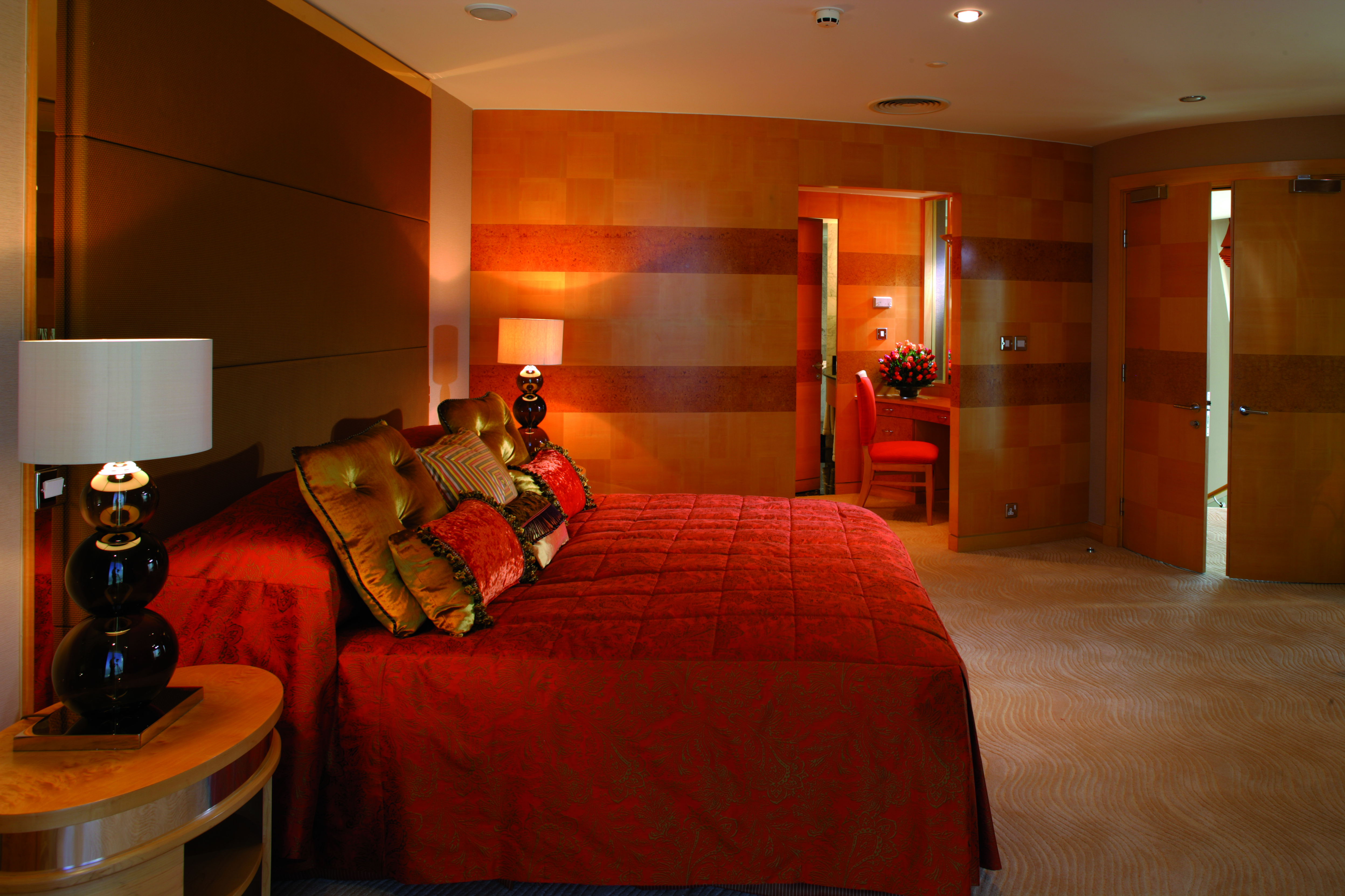 The Jumeirah Beach Hotel Dubai red bedroom with view of seating area