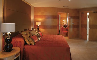The Jumeirah Beach Hotel Dubai red bedroom with view of seating area