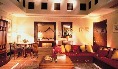The Jumeirah Beach Hotel Dubai villa lounge with large sofa and table with view of bedroom