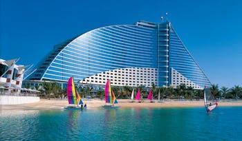 The Jumeirah Beach Hotel Dubai windsurfing on the beach overlooked by hotel
