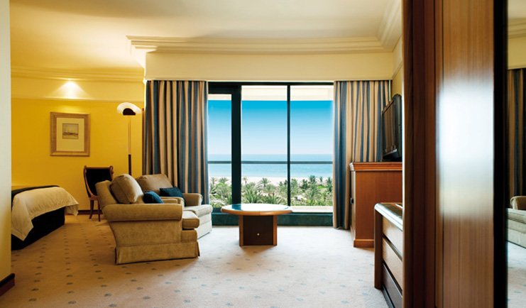 Le Royal Meridien Beach Resort and Spa Dubai club room bedroom with sofa and sea view