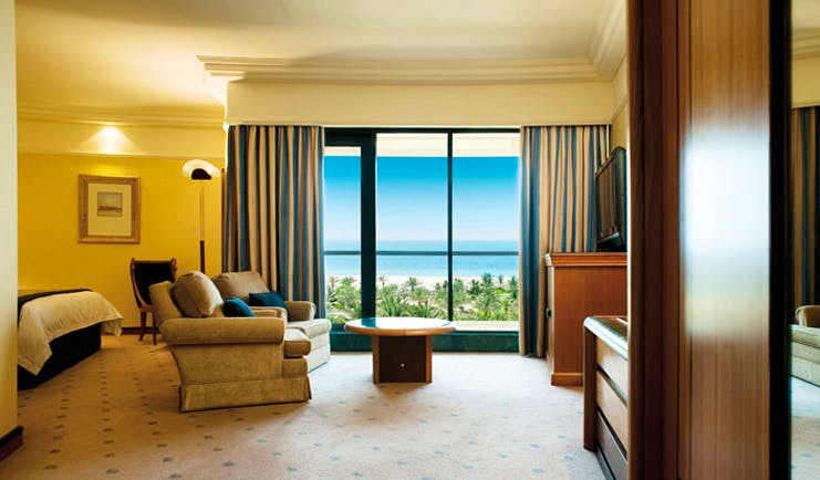 Le Royal Meridien Beach Resort and Spa Dubai club room bedroom with sofa and sea view