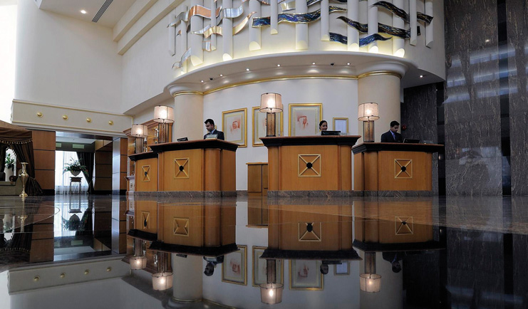 Le Royal Meridien Beach Resort and Spa Dubai lobby with several reception desks