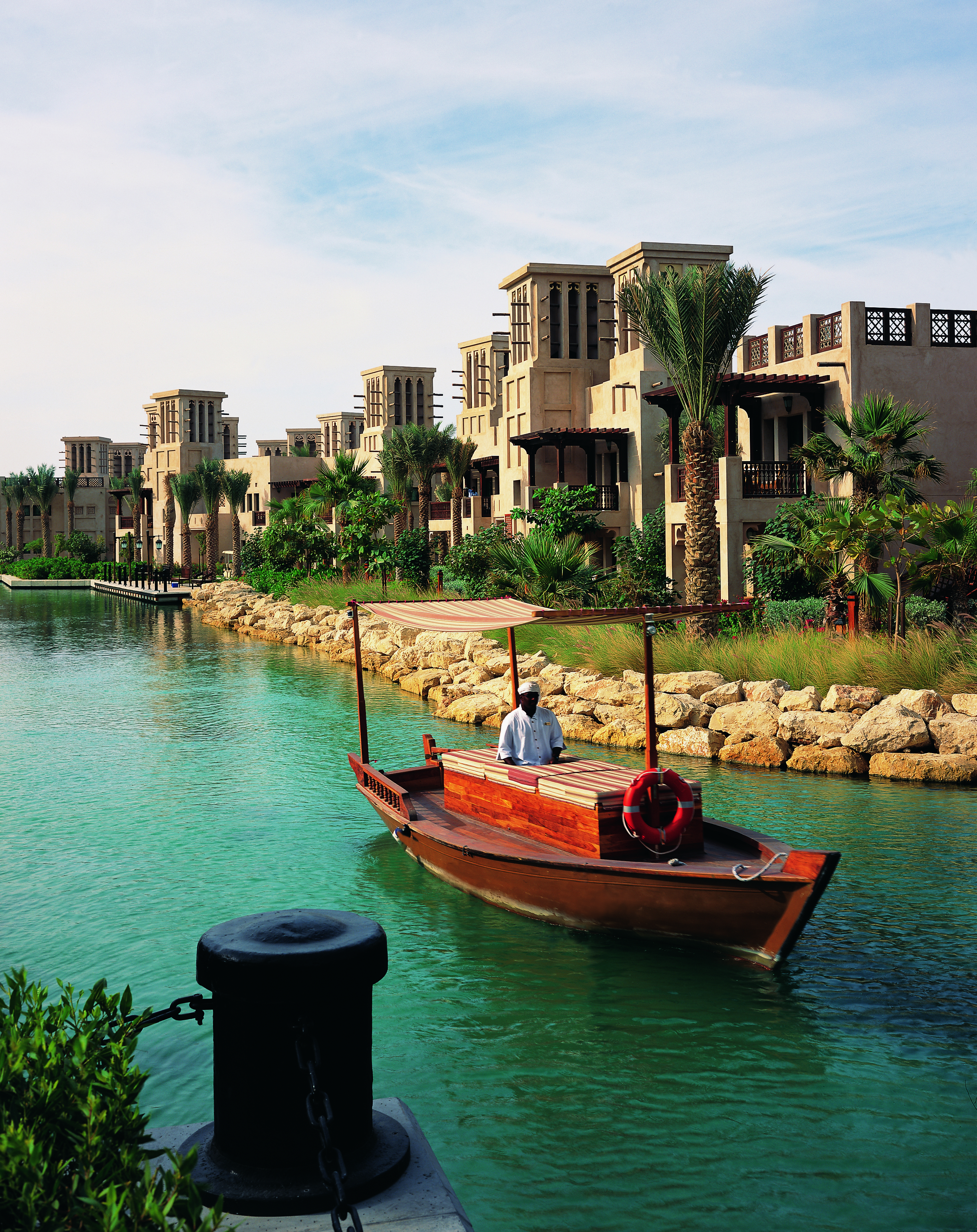 Madinat Jumeirah Dubai complex of buildings with balconies overlooking traditional boat