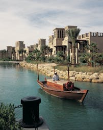 Madinat Jumeirah Dubai complex of buildings with balconies overlooking traditional boat