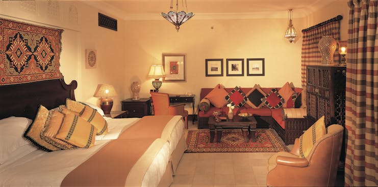 Madinat Jumeirah Dubai Dar Al Maysaf bedroom with sofa and armchair