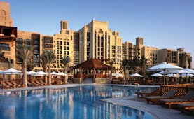 Madinat Jumeirah Dubai hotel pool view overlooking swimming pool with loungers and umbrellas