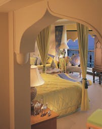 Madinat Jumeirah Dubai suite bedroom with armchair and wardrobe