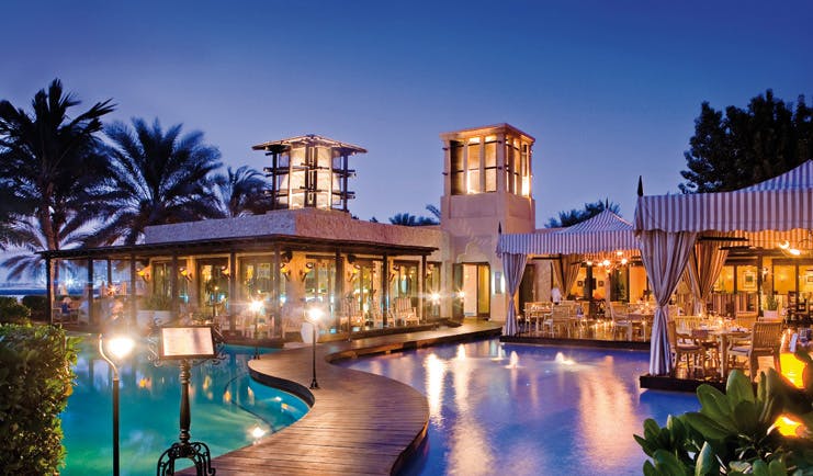 One and Only Royal Mirage Dubai pool with walkway and covered seating areas