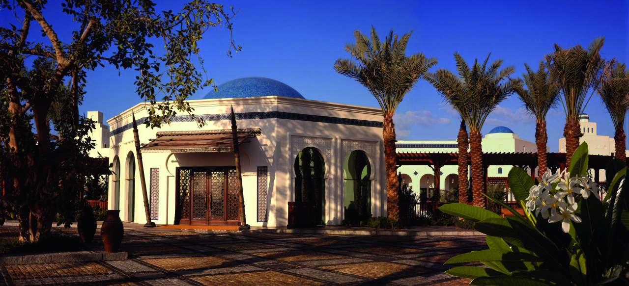 Park Hyatt Dubai exterior white building with domed roof and palm trees