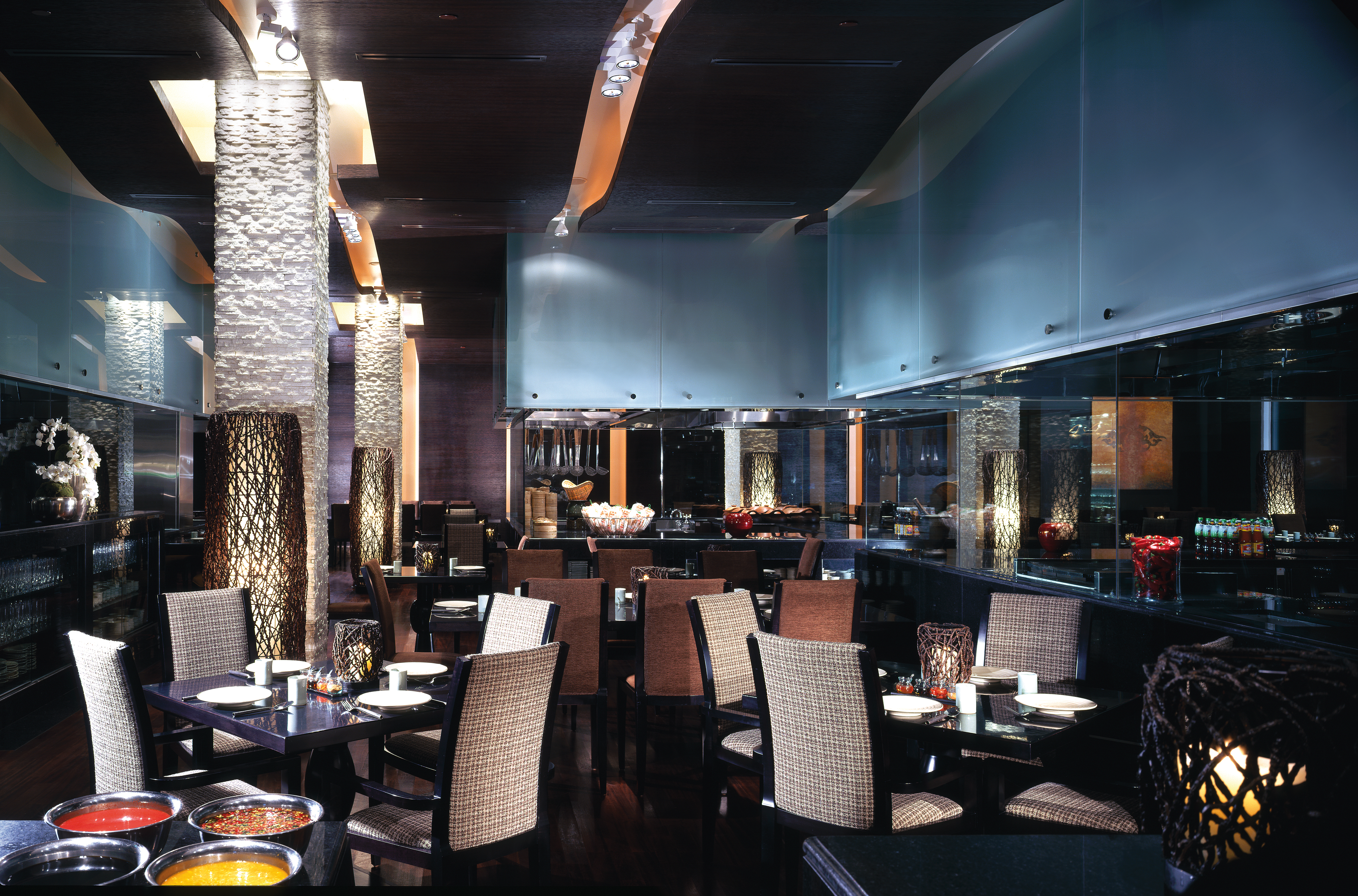 Restaurant with tables and chairs set out for dining 