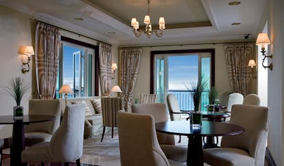 The Ritz-Carlton Dubai lounge with sofas tables and chairs and balcony access