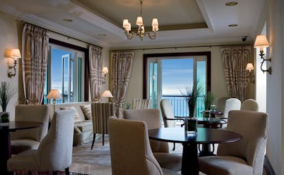 The Ritz-Carlton Dubai lounge with sofas tables and chairs and balcony access