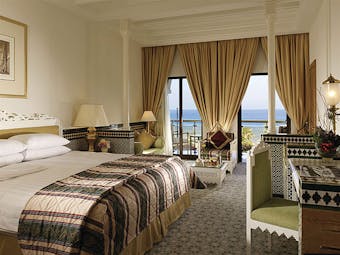 Al Bustan Palace Hotel Oman Arabian deluxe bedroom with Arabic design details and balcony