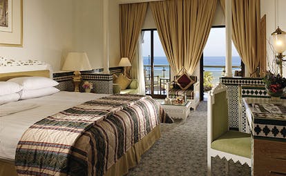 Al Bustan Palace Hotel Oman Arabian deluxe bedroom with Arabic design details and balcony