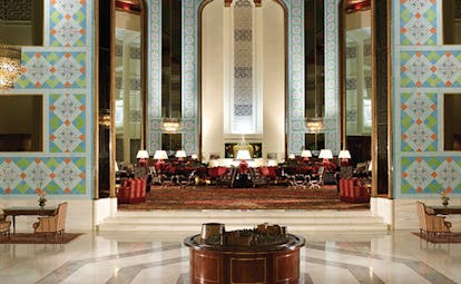 Al Bustan Palace Hotel Oman atrium with colourful wall tiles and seating area