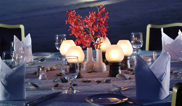 Al Bustan Palace Hotel Oman beach pavilion restaurant with lanterns and red flowers at night