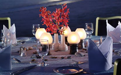 Al Bustan Palace Hotel Oman beach pavilion restaurant with lanterns and red flowers at night