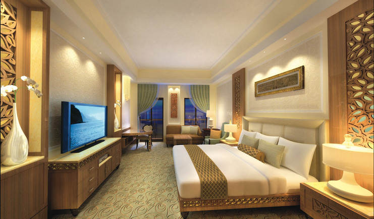 Al Bustan Palace Hotel Oman bedroom with television sofa and balcony