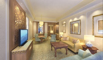 Al Bustan Palace Hotel Oman suite sitting room with sofa and armchairs