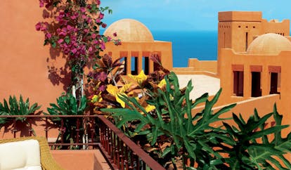 Shangri La Barr Al Jissah Resort and Spa Oman balcony and chair on balcony overlooking beach and pool