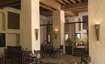 Six Senses Zighy Bay Oman bar with stone walls and wooden furniture
