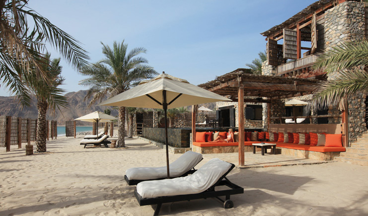 Six Senses Zighy Bay Oman beach lounge terrace private beach area with loungers and umbrellas
