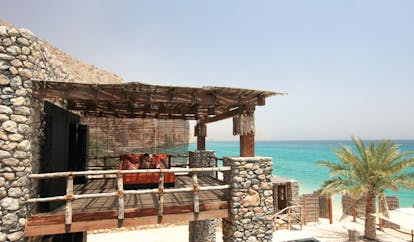 Six Senses Zighy Bay Oman bedroom balcony with bed lounger and sea view