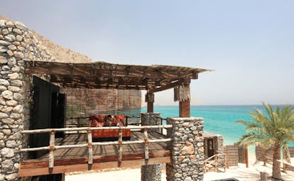 Six Senses Zighy Bay Oman bedroom balcony with bed lounger and sea view