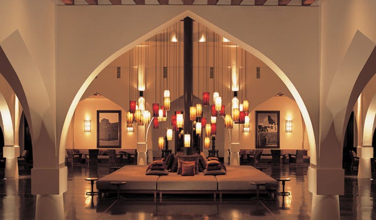 The Chedi Muscat Oman lobby lounge with large archway and sofas