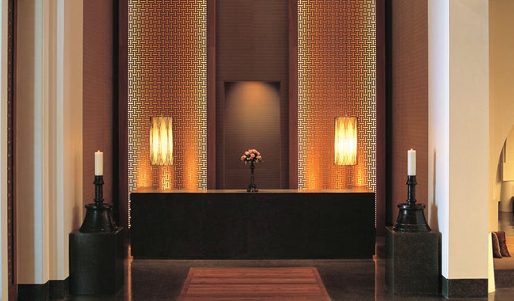 The Chedi Muscat Oman reception desk with candles and flowers