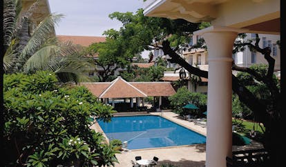 Raffles Hotel Le Royal Cambodia aerial pool gardens trees hotel building