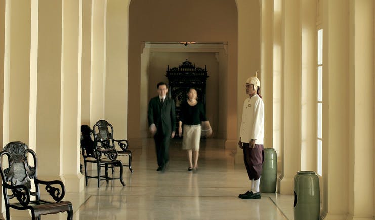 Raffles Hotel Le Royal Cambodia hallway couple staff member in formal uniform