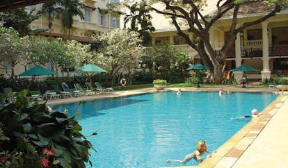 Raffles Hotel Le Royal Cambodia hotel pool courtyard gardens loungers