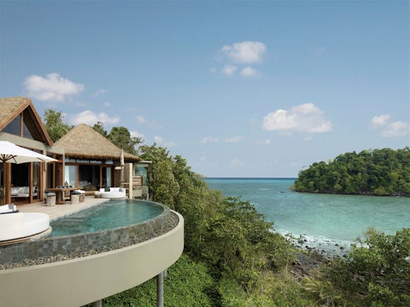 Overview of the Song Saa Private island showing beach hut style buildings with an infinity pool looking over the ocean