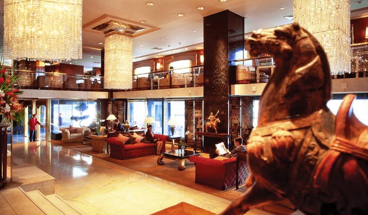 Mandarin Oriental lobby with horse statue, large chandeliers and high ceilings