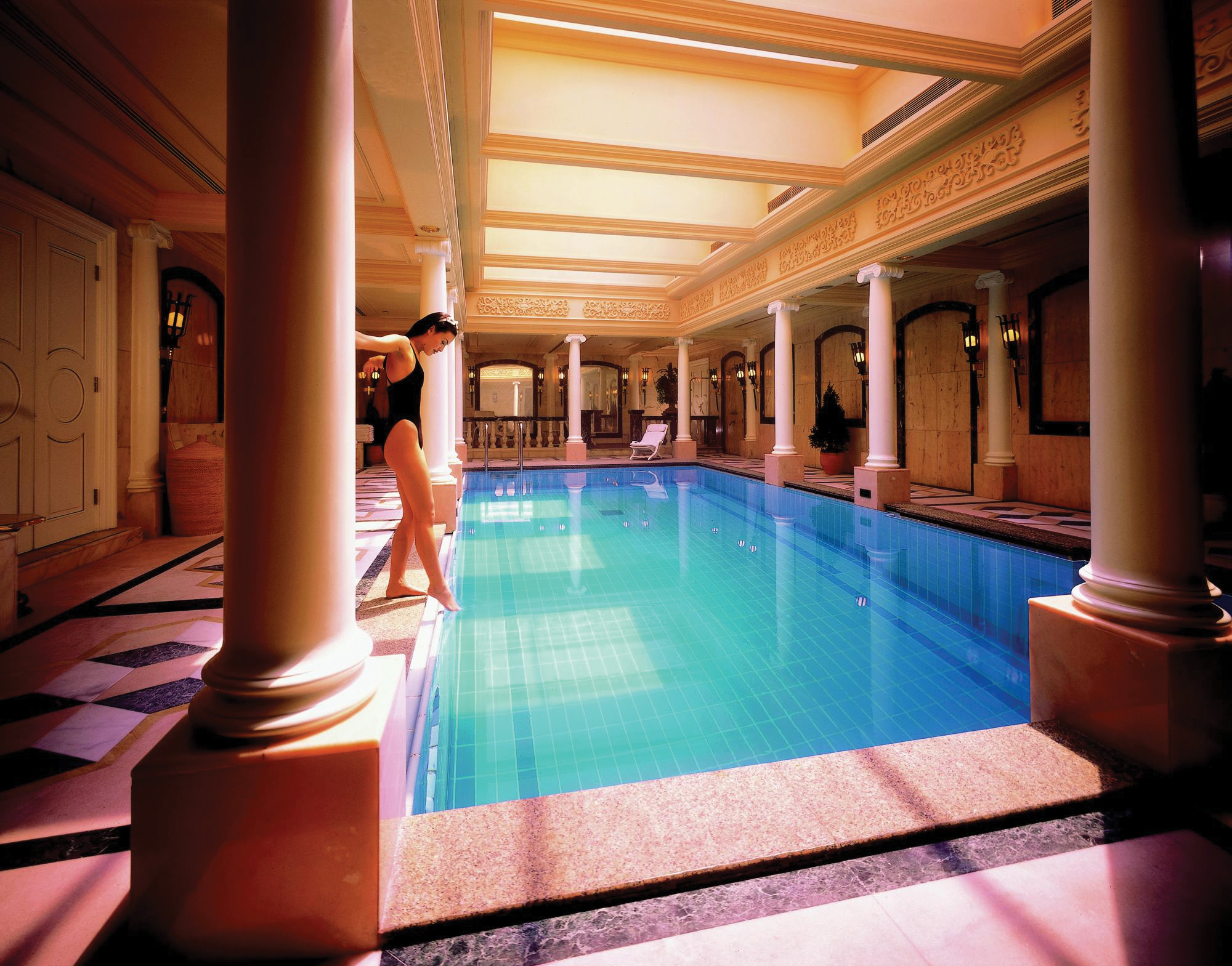 Mandarin Oriental Hong Kong pool indoors ornate architecture woman dipping toe in