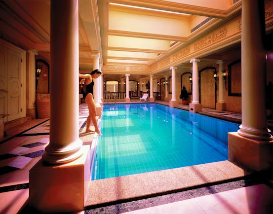 Mandarin Oriental Hong Kong pool indoors ornate architecture woman dipping toe in