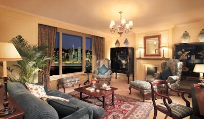 The Peninsula Hong Kong deluxe harbour view lounge classic traditional decor sitting area chandelier antiques city view