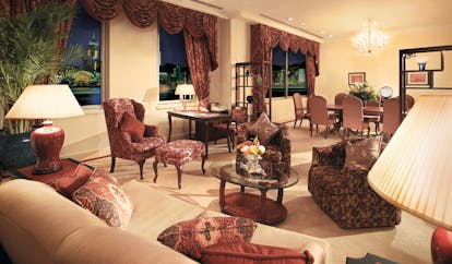 The Peninsula Hong Kong deluxe suite lounge classic decor seating area armchairs curtain drapes